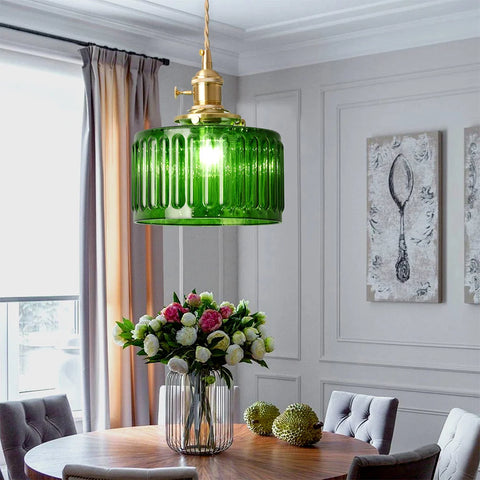 Green glass pendant light over a kitchen counter