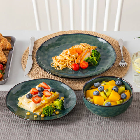 Deep green stoneware bowls filled with salad