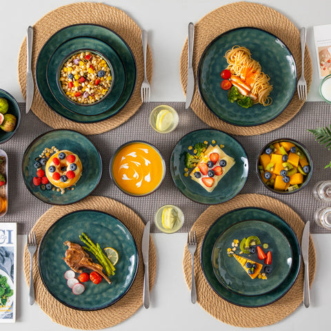 Table laid with green stoneware bowls and serving dishes