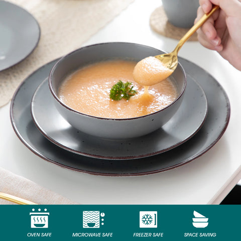 Grey stoneware bowl of soup on a laid table