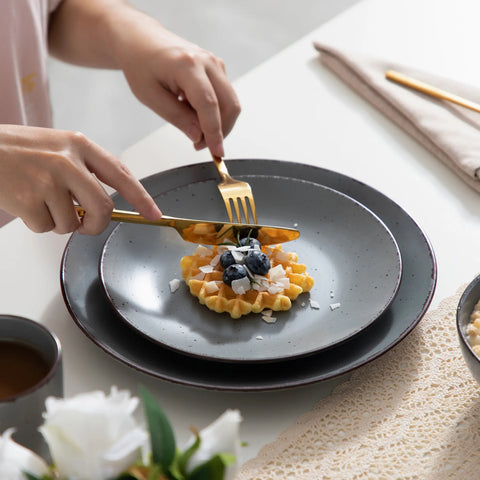 Serving food onto a grey speckled stoneware plate