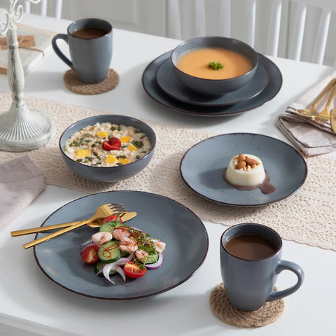 Grey stoneware plates with a meal on a dining table