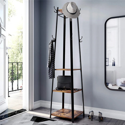 Black iron coat stand with shelves beside a mirror