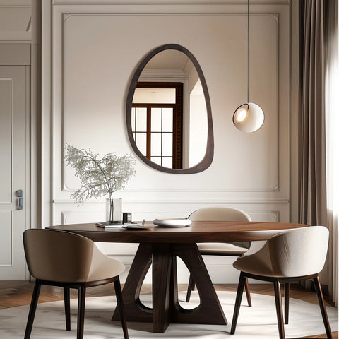 Irregular walnut wall mirror above a dining table and chairs
