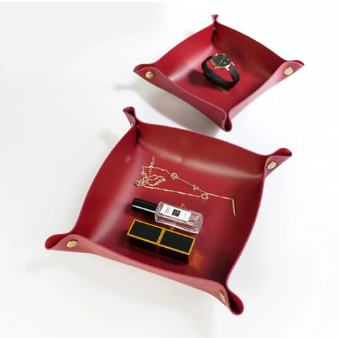 Burgundy leather valet tray holding a ring box