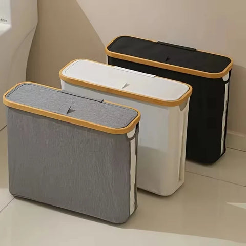 Three lidded storage baskets in grey, black and beige with bamboo lids