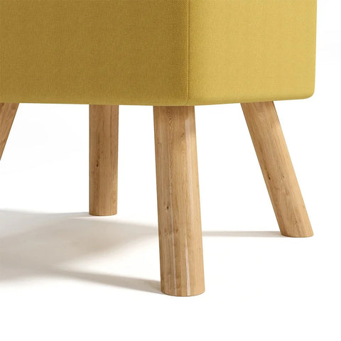 Linen footstool, close view of the pine legs and quilted seat