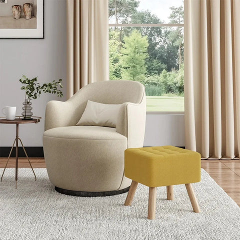 Yellow linen footstool beside a cream armchair