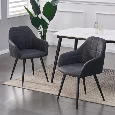 Pair of dark grey matte suede dining chairs at a white dining table