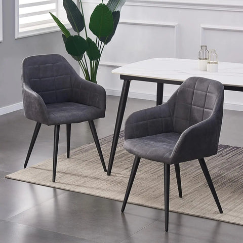 Pair of grey matte suede dining chairs at a white dining table