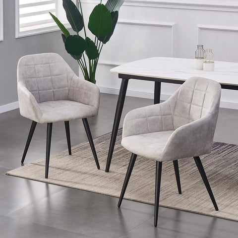Pair of light grey matte suede dining chairs at a white dining table