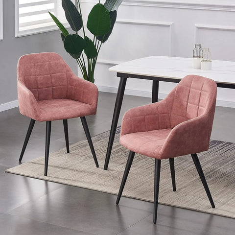 Pair of pink matte suede dining chairs at a white dining table