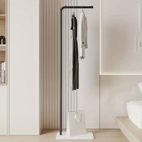 Black valet stand holding hanging clothes