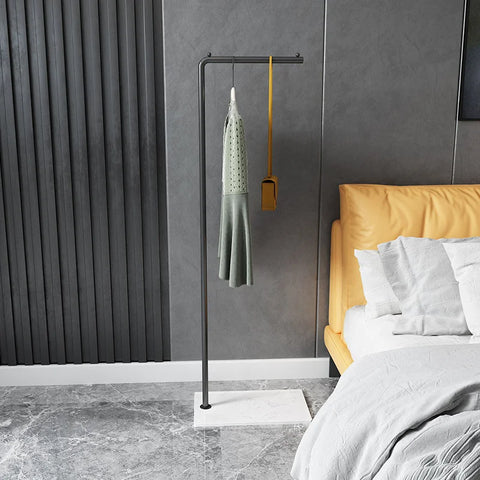 Gold valet stand beside a bed