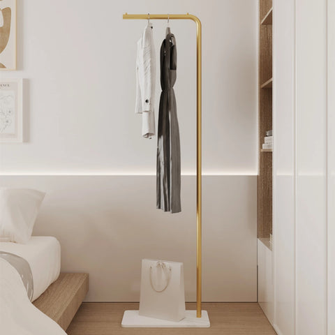 Gold valet stand against a panelled wall