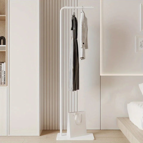 White valet stand holding hanging clothes