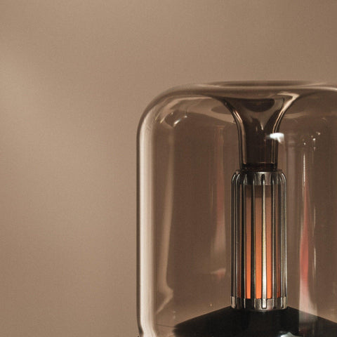 Close-up of the Mistt diffuser's glass chamber and warm filament lamp