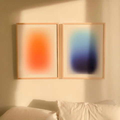 Modern gradient art prints, a pair in wooden frames on a softly lit wall