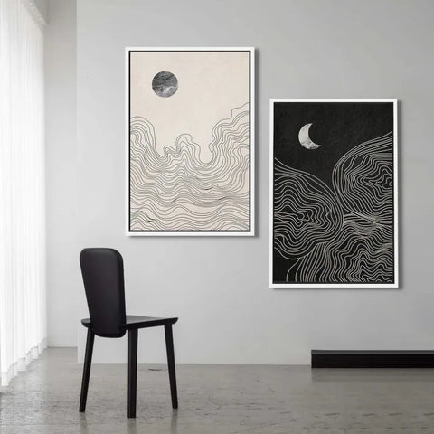 Night and Day art prints hung on a wall above a black chair