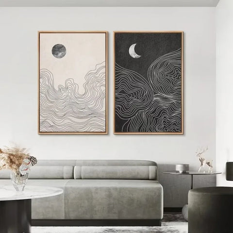 Night and Day art prints in a living room above a grey sofa