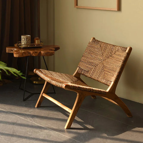 Woven rattan lounge chair beside a small side table