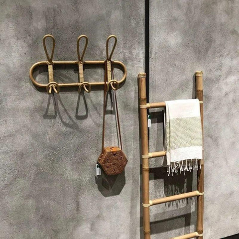 Rattan wall hook rack holding towels in a bathroom
