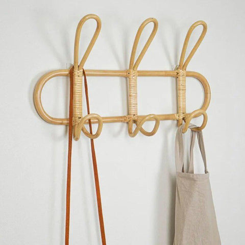 Rattan wall hook rack holding a canvas tote bag