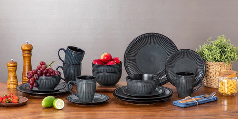 Ribbed ceramic dinner set arranged on a dark surface