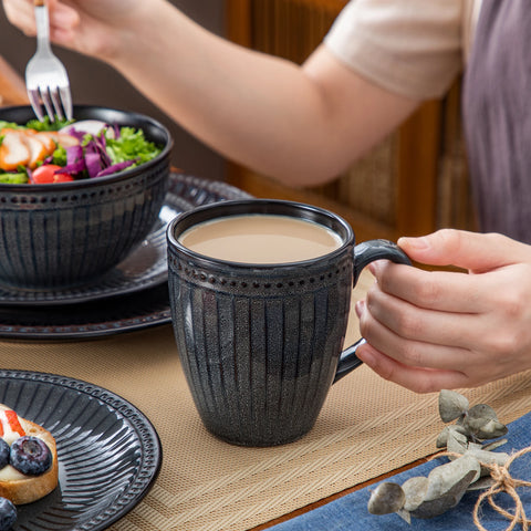 Holding a ribbed ceramic mug, close view of the fluted surface