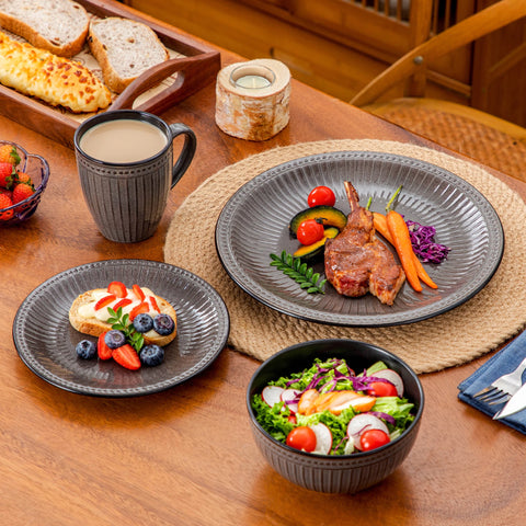 Ribbed ceramic plates served with food on a laid table