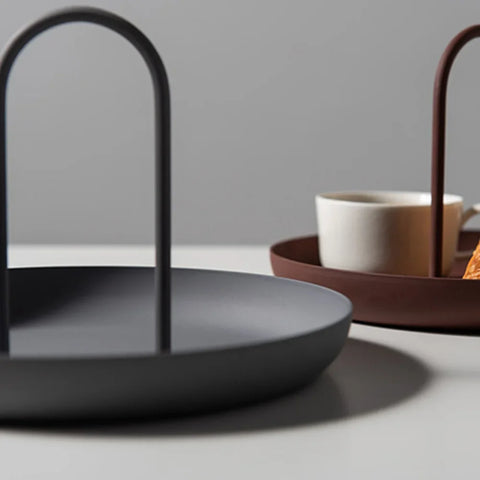 Black and crimson round handled trays with a mug