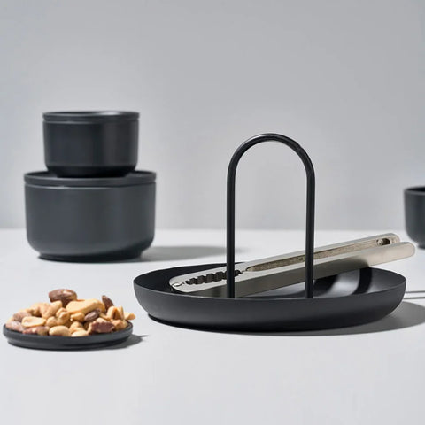 Black round handled tray with snacks and small pots