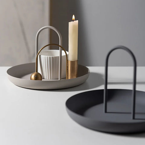 Round handled trays styled with candles and a jug