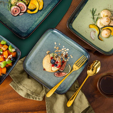 Plated dish on a square green stoneware plate with gold cutlery
