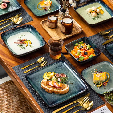Table laid with square green plates and small side bowls