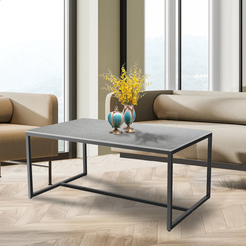 Grey stone coffee table with a black metal frame in a living room