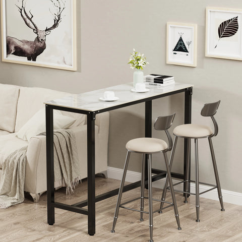 Stone top bar table with stools against a panelled wall