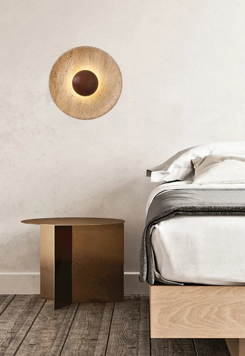 Stone and wood wall light beside a bed and side table
