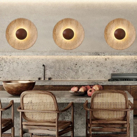 Three stone and wood wall lights above a travertine dining counter
