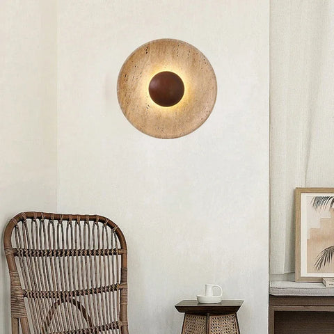 Stone and wood wall light above a rattan chair