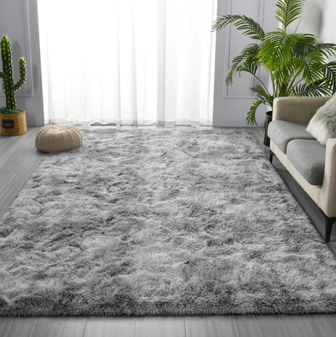 Light grey tie-dye shaggy rug in a bright living room beside a sofa