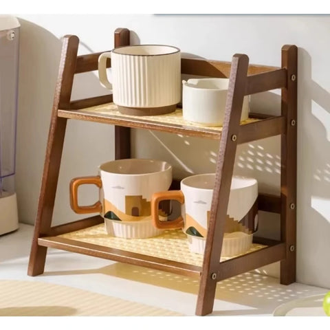 Two-tier bamboo shelf in dark brown holding mugs and a jug