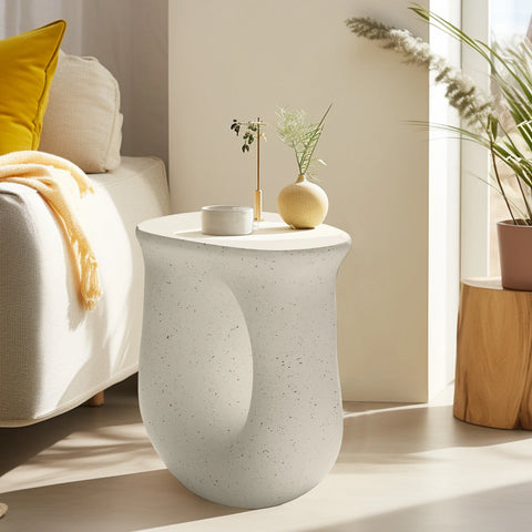 U-shaped concrete side table in a bedroom corner with a plant