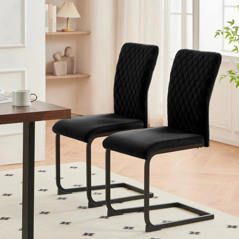 Two black velvet high back dining chairs on cantilever frames