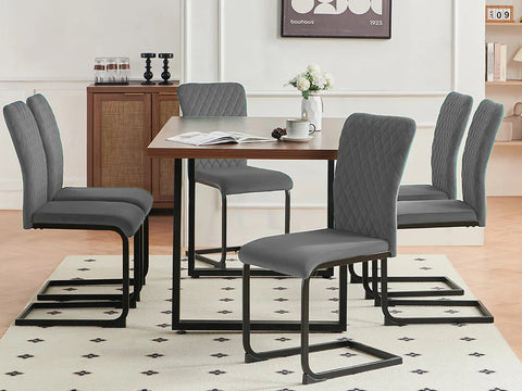 Grey velvet high back dining chairs around a dining table