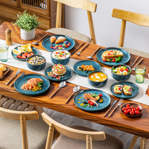 Dining table laid with vertical edge blue plates and bowls