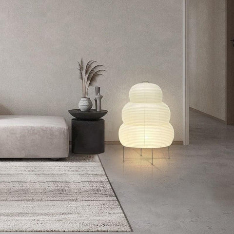 Tiered paper lantern lamp lit in a living room