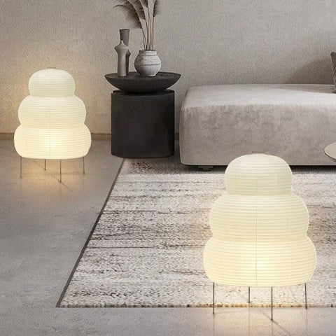 Two tiered paper lantern lamps lit in a neutral living room