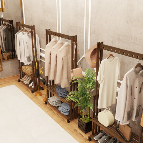 Walnut bamboo clothes stand with hanging clothes and a plant