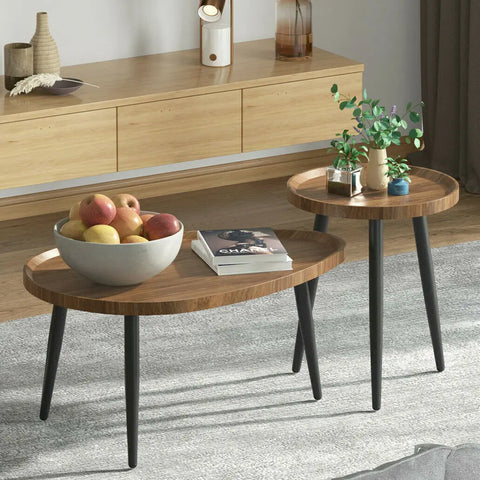 Walnut nesting coffee tables with a bowl of fruit in a living room